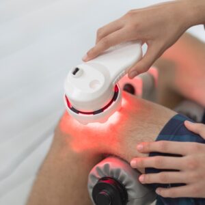 Man using a SunPowerLED Palm on his knee