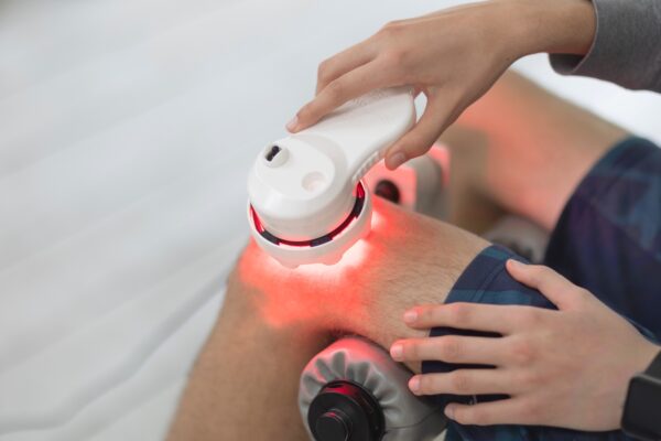 Man using a SunPowerLED Palm on his knee